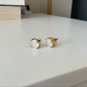 White stone stud earrings with gold-toned backing